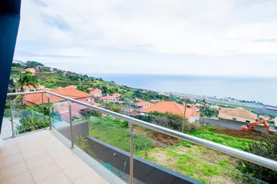 a balcony with a view of the ocean at Bugio Guesthouse in Santa Cruz
