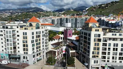 an aerial view of a city with white buildings at Fórum Madeira Residence in Funchal