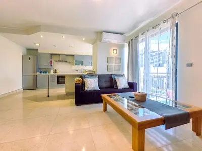 a living room with a couch and a table at Fórum Madeira Residence in Funchal