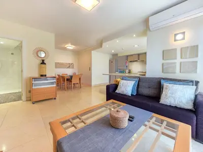 a living room with a couch and a table at Fórum Madeira Residence in Funchal