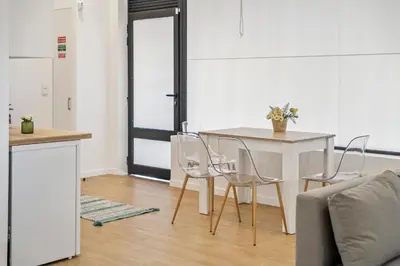 a kitchen with a table and chairs in a room at Casa Isaurinha by ALMA Holiday Rentals in Caniço