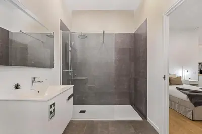 a bathroom with a shower and a sink at Casa Isaurinha by ALMA Holiday Rentals in Caniço