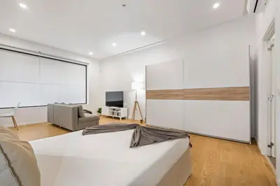a white room with a bed and a couch at Casa Isaurinha by ALMA Holiday Rentals in Caniço