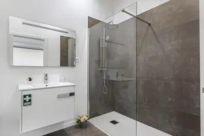 a bathroom with a shower and a sink at Casa Isaurinha by ALMA Holiday Rentals in Caniço