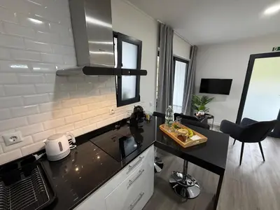 a kitchen with a black counter top in a room at Stay Lombinho in Porto da Cruz