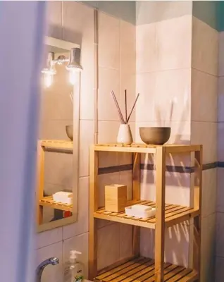 a bathroom with wooden shelves with bowls and utensils at Casa Monki in Raposeira