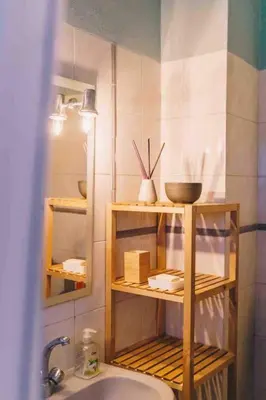 a bathroom with wooden shelves and a sink and a mirror at Casa Monki in Raposeira