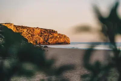 a view of a beach with a cliff at Casa Monki in Raposeira