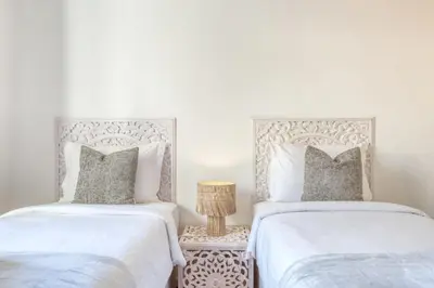 two beds sitting next to each other in a bedroom at Funchal Panoramic View, a Home in Madeira in Funchal