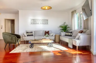 a living room with two couches and a coffee table at Funchal Panoramic View, a Home in Madeira in Funchal