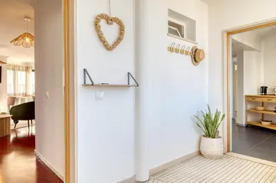 a living room with a heart wreath on the wall at Funchal Panoramic View, a Home in Madeira in Funchal