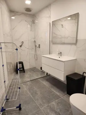 a white bathroom with a sink and a shower at Santa Beatriz Apartment in Machico