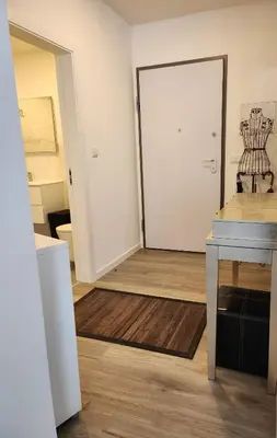 a room with a white door and a wooden floor at Santa Beatriz Apartment in Machico