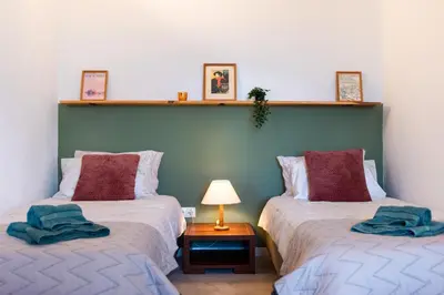 two beds sitting next to each other in a room at Seaview Ensuite rooms in Sagres centre - Casa Maluka in Sagres