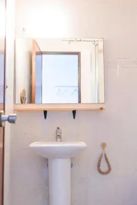 a bathroom with a sink and a mirror at Seaview Ensuite rooms in Sagres centre - Casa Maluka in Sagres