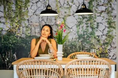 a woman sitting at a table in a restaurant at Villa Monte in Funchal
