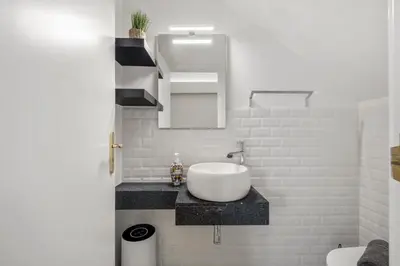 a white bathroom with a sink and a mirror at Villa Monte in Funchal