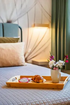 a tray with a plate of food on a bed at Villa Monte in Funchal