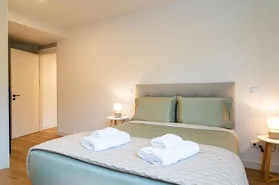 a bedroom with a bed with two towels on it at A peaceful retreat near the city centre in Funchal