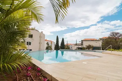 a swimming pool in the middle of a building at A peaceful retreat near the city centre in Funchal