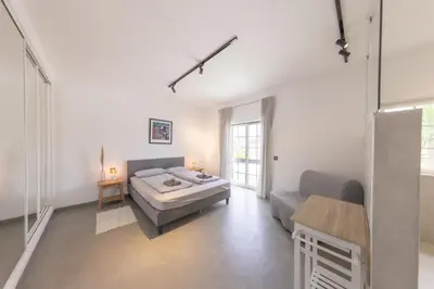 a bedroom with a bed and a couch and a table at Living Lodge Portugal in Aljezur