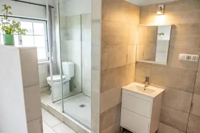 a bathroom with a shower and a toilet and a sink at Living Lodge Portugal in Aljezur