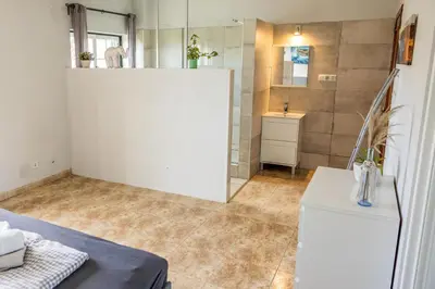 a bathroom with a white wall and a sink at Living Lodge Portugal in Aljezur
