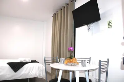 a small room with a bed and a table at Leais ao Pico in Porto da Cruz