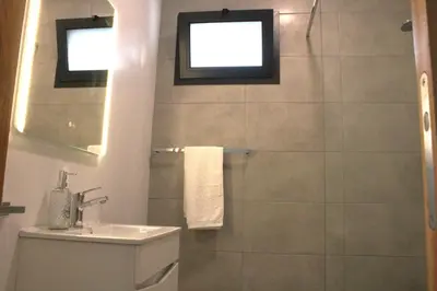 a bathroom with a shower and a toilet and a sink at Leais ao Pico in Porto da Cruz