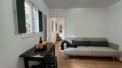 a living room with a couch and a table at Rosalita s View in Funchal