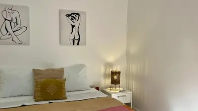 a bedroom with a bed and a lamp on a night stand at Rosalita s View in Funchal