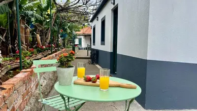a table with a hot dog and two glasses of orange juice at Rosalita s View in Funchal