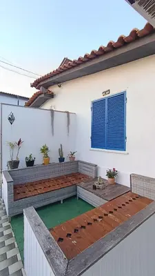 a backyard patio with a bench and a table at Kanela Guest House B-side in Machico