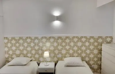 two beds sitting next to each other in a bedroom at Apartamento Vista Mar in Funchal