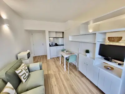 a living room with a couch and a table with a tv at Apartamento Vista Mar in Funchal