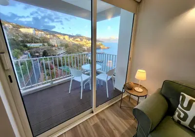 a living room with a balcony with a view of the ocean at Apartamento Vista Mar in Funchal