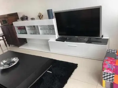 a white entertainment center with a flat screen tv at GuestReady - Vila Rosa - Renovated Seaviews House in Funchal