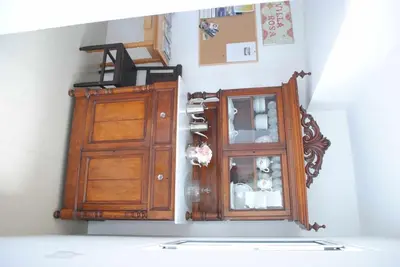 a room with a wooden cabinet and a window at GuestReady - Vila Rosa - Renovated Seaviews House in Funchal