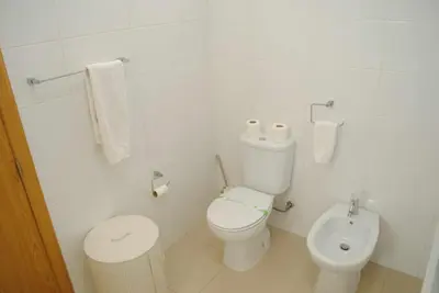 a white bathroom with a toilet and a bidet at GuestReady - Vila Rosa - Renovated Seaviews House in Funchal