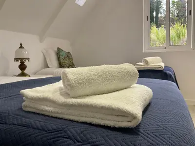 a pile of towels sitting on top of a bed at Sol & Mar Casa Branca in Funchal