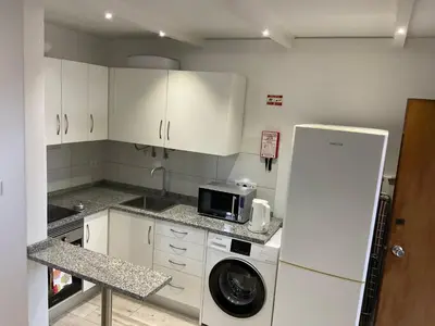 a kitchen with a refrigerator and a washing machine at Sol & Mar Casa Branca in Funchal