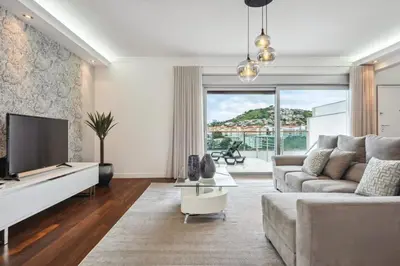 a living room with a couch and a tv at Suburban Views by Homie in Funchal