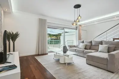 a living room with a couch and a table at Suburban Views by Homie in Funchal