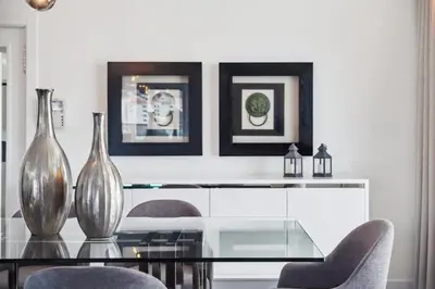 a dining room with a glass table and two vases at Suburban Views by Homie in Funchal