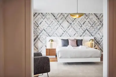 a bedroom with a white bed and a chair at Suburban Views by Homie in Funchal
