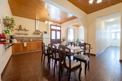 a kitchen and dining room with a table and chairs at Domingos House - Valley View in Boaventura