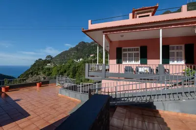 a house with a balcony with a view of the ocean at Domingos House - Valley View in Boaventura