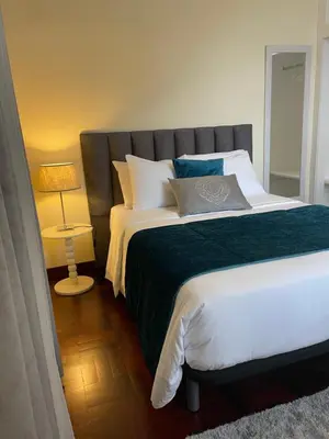 a bedroom with a large bed and a mirror at Domingos House - Valley View in Boaventura