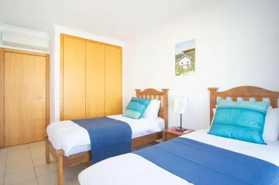 a hotel room with two beds with blue and white at Baleias Guesthouse - 3 Bedroom Townhouse with private pool & sea view in Luz