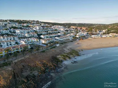 an aerial view of a beach with houses and the ocean at Baleias Guesthouse - 3 Bedroom Townhouse with private pool & sea view in Luz